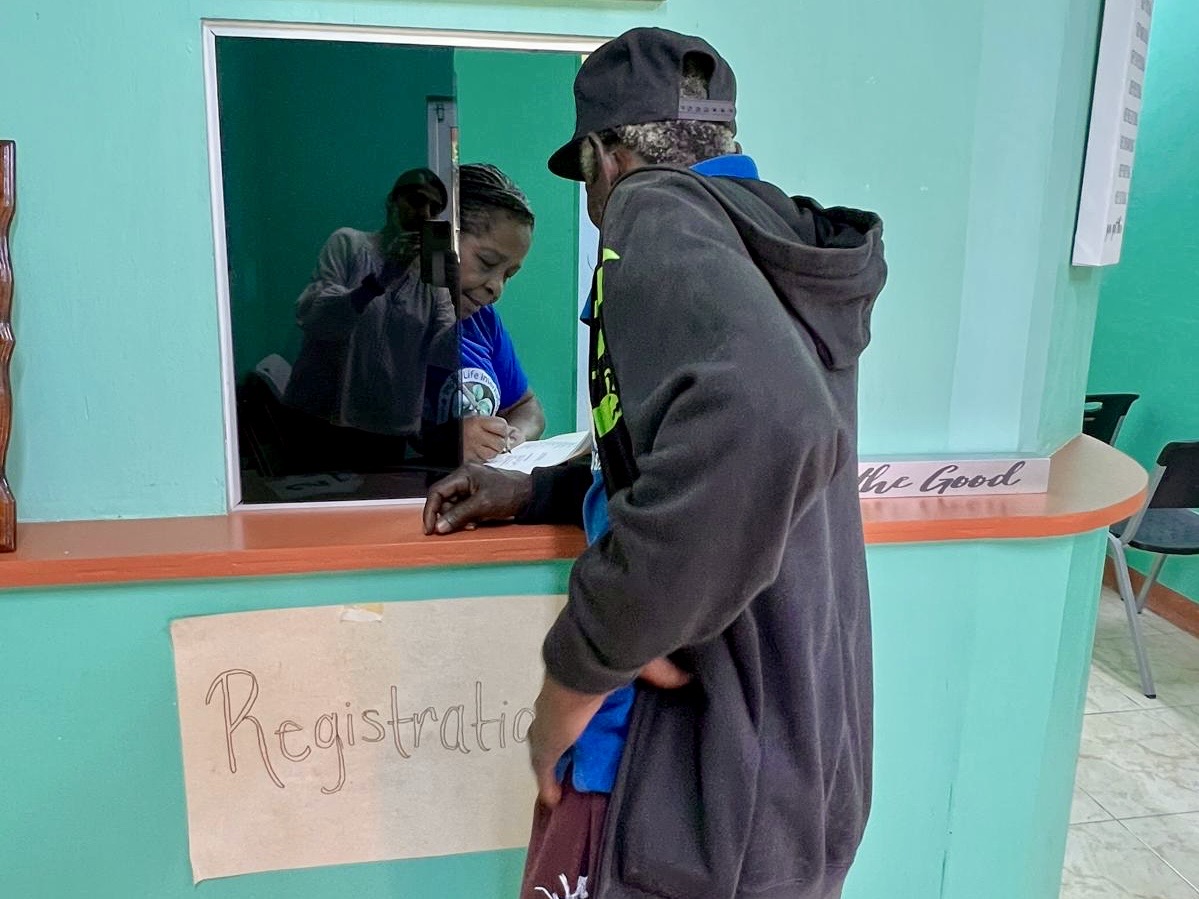 A visitor registering at the Bunkers Hill Health Center check-in window